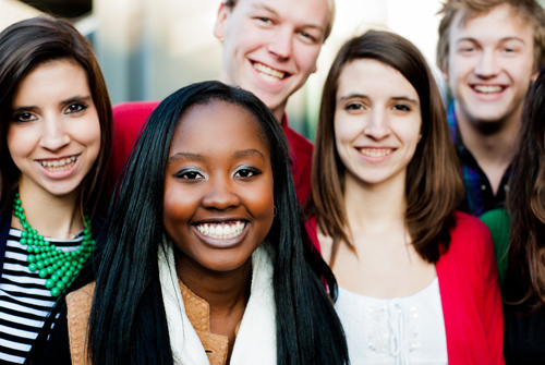 A group of smiling male and female students