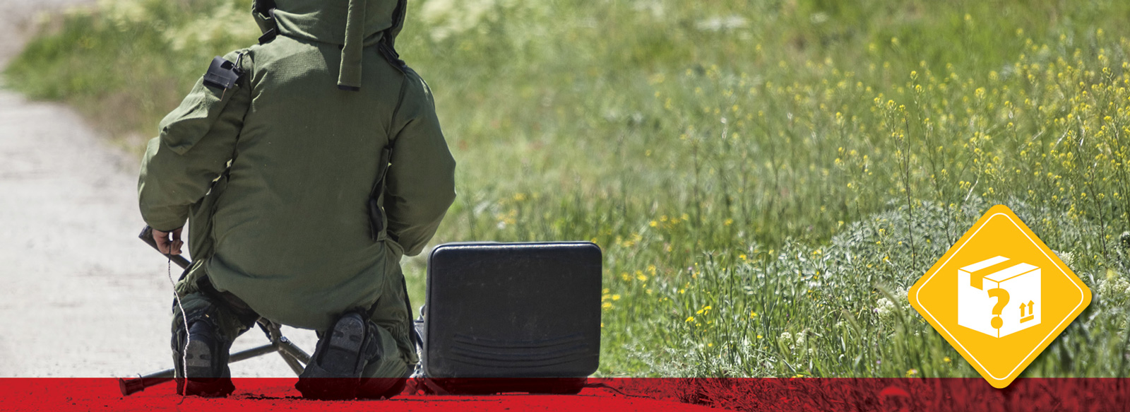 Photo of a bomb expert working to defuse a bomb in a gym bag