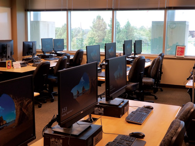 Rows of computers on the tables of the computer lab.