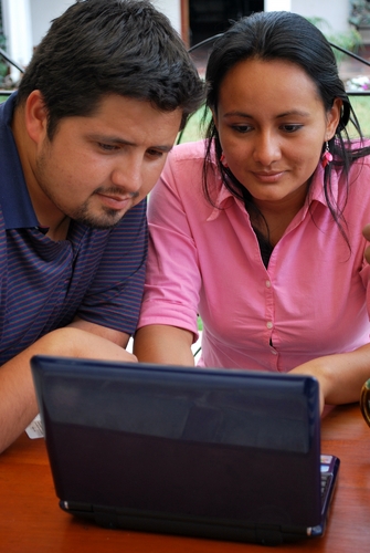 Hispanic students using a laptop
