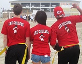 Three students show the backs of their t-shirts, which read Lee College