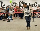 A male student dances before an audience