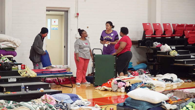 People and bedding in Lee College's shelter during Hurricane Harvey.