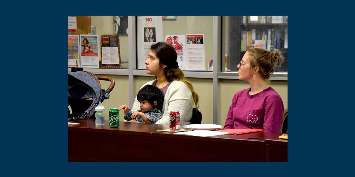 Student moms and a child on one's lap.