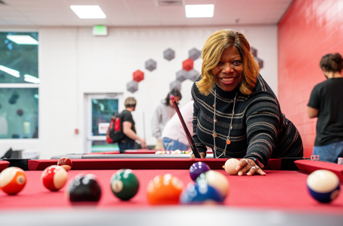 Gina Guillory, Lee College Board of Regents, plays a game of pool in the Game Room during the grand re-opening celebration for the renovated Student Center.