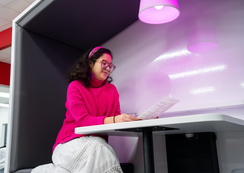 Valerie Garza, Lee College student and TRiO employee, enjoys one of several study pods in the Learning Hub of the renovated Student Center.