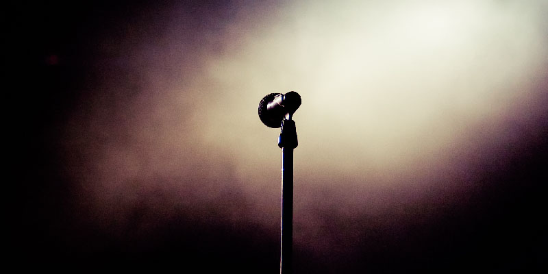 A microphone on a dark stage