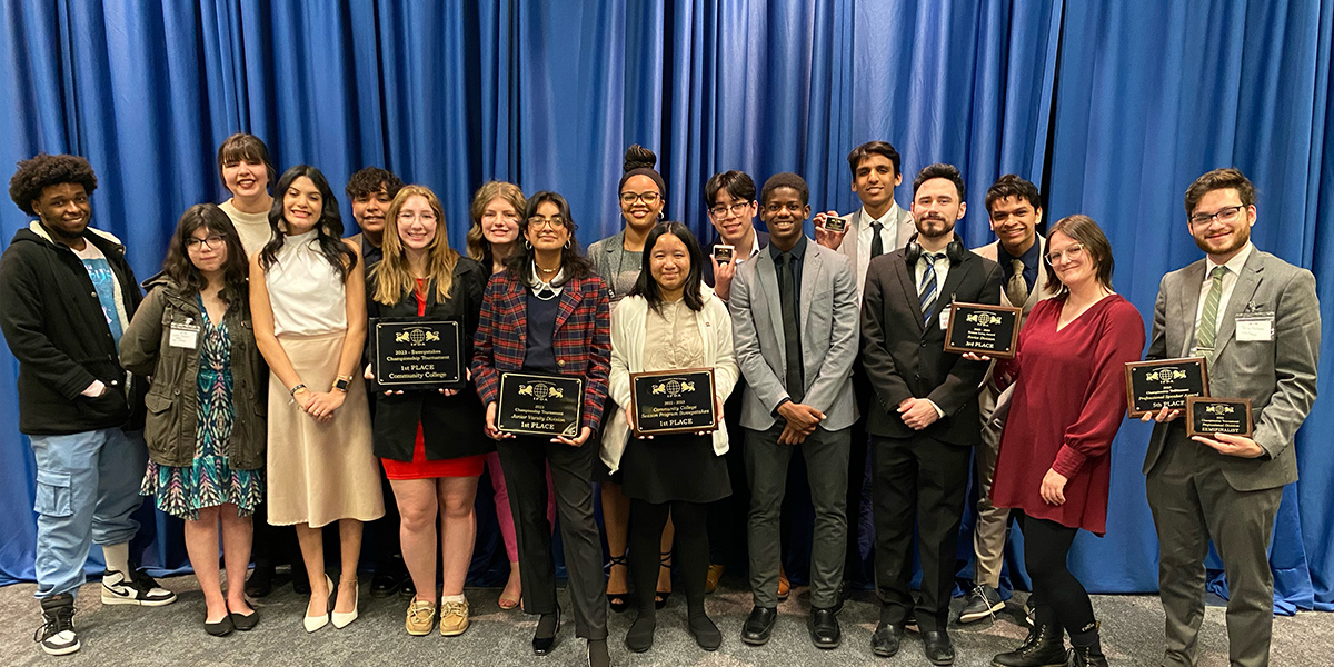 The debate team poses with its awards