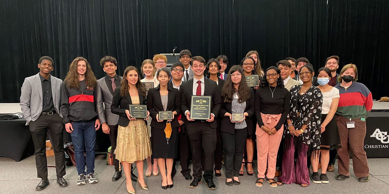 The Lee College debate team poses with its trophies