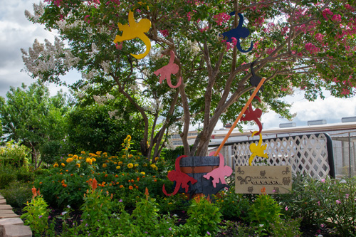 Wooden monkeys hang from trees