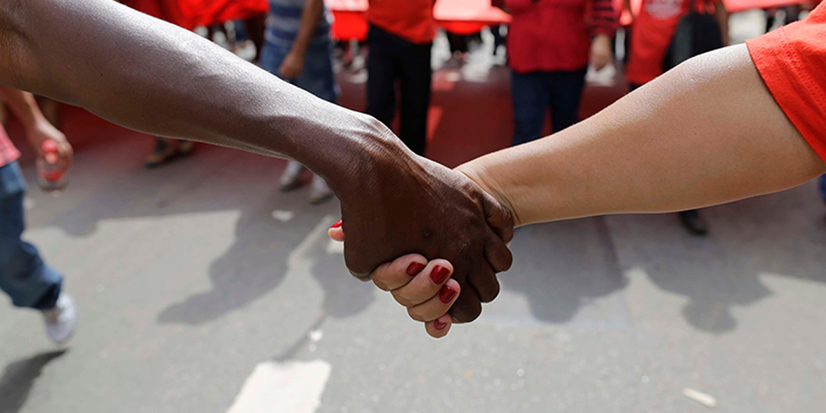 Black and white hands joined together