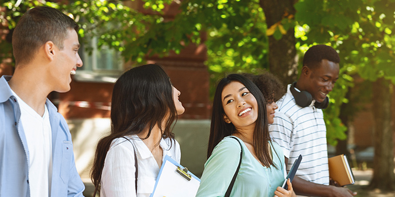 Students smiling and walking outside