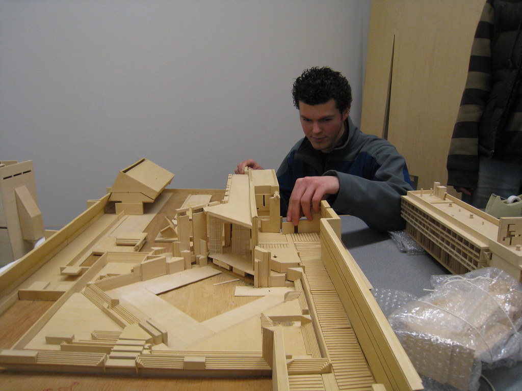 A man working on a model of a structure
