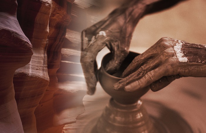 Hands creating pottery