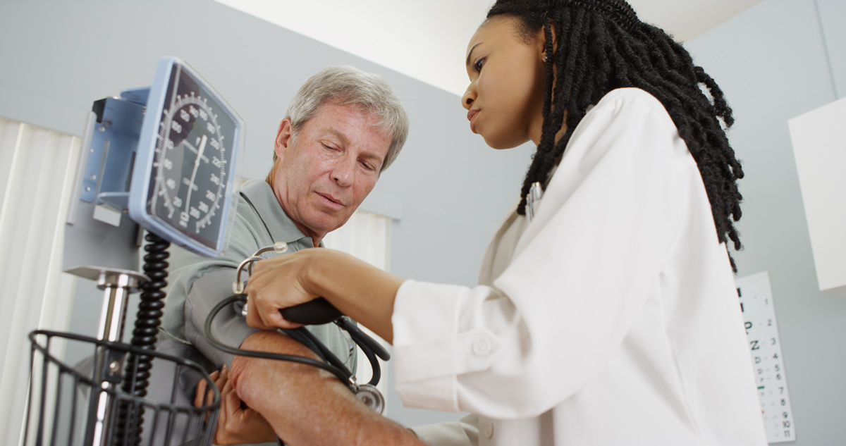 A medical professional takes a patient's blood pressure